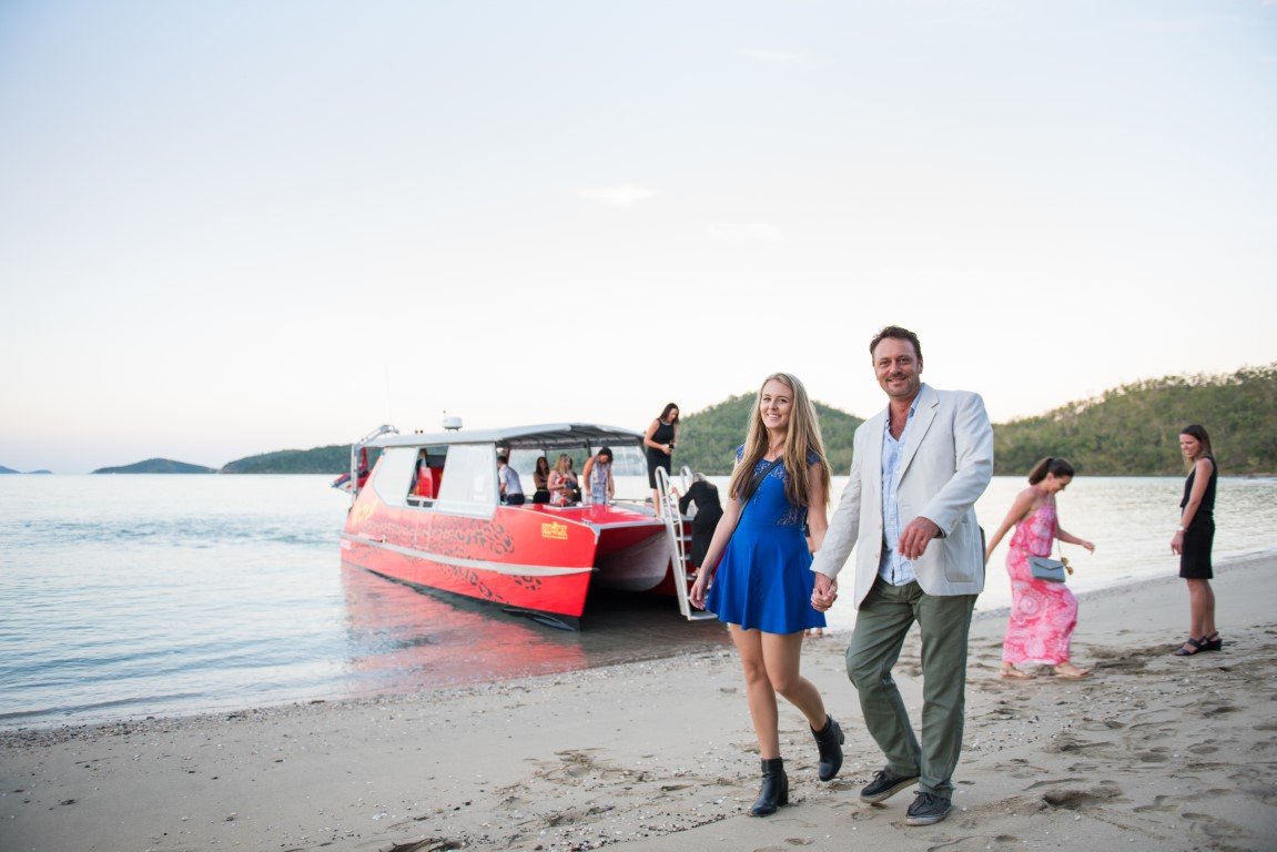 arriving to the wedding by boat , true whitsundays style