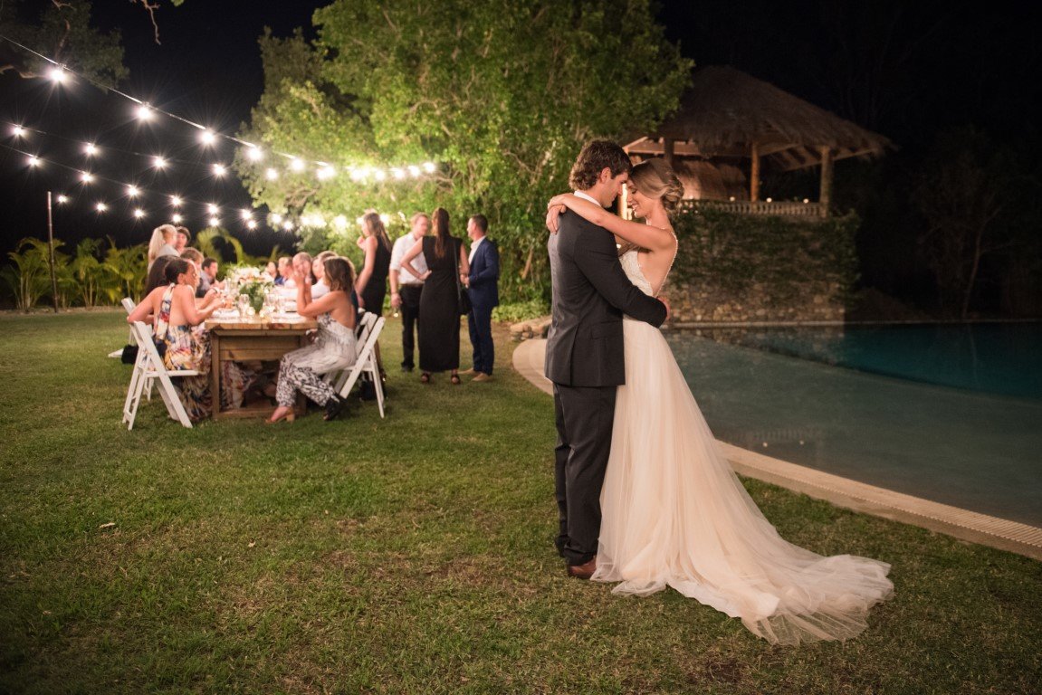 Bride and Groom by a pool and wedding reception at Paradise Cove Resort