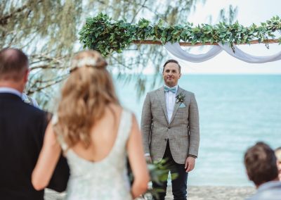 Groom sees bride for the first time as she walks down the aisle at Paradise Cove Resort in the Whitsundays