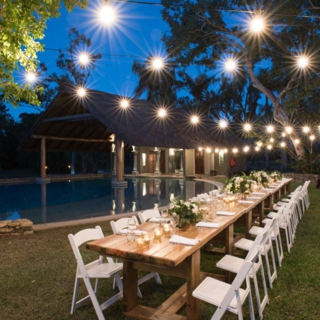 Poolside wedding reception with fairy lights