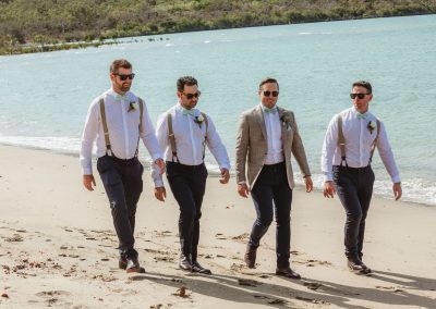 Groom with groomsmen walking on beach at Paradise Cove Resort in the Whitsundays