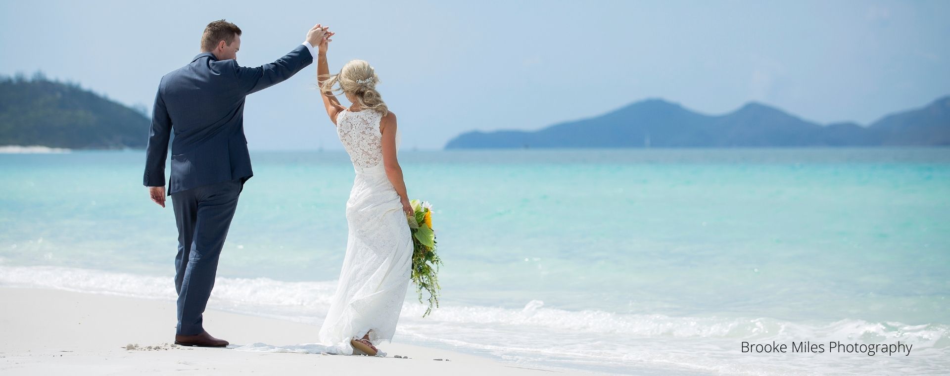 Bride and Groom dancing on a white beach